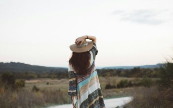 Wallpaper Standing Woman Holding Hat on Road