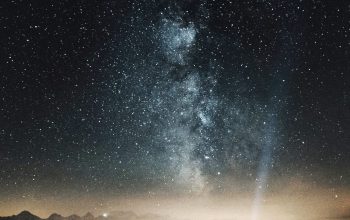 Wallpaper Silhouette of Person on Mountaintop with Flashlight