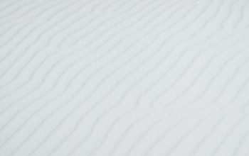 Wallpaper A Person Skiing Down a Snowy Slope
