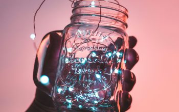 Wallpaper Person Holding Clear Glass Mason Jar with Strip Lights Inside