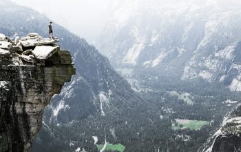 Wallpaper Man on Mountain Cliff