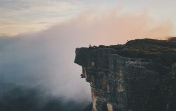 Wallpaper Person Sitting on Mountain Cliff