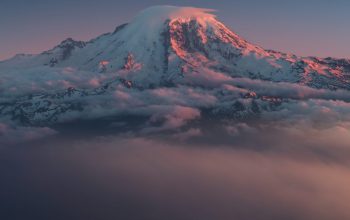Wallpaper Icy Mountain Covered in White Clouds