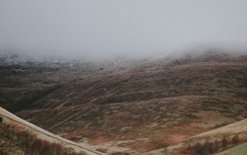 Wallpaper Aerial Photography of Hill and Field Under White Sky at Daytime