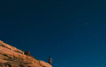Wallpaper Person in Gray Shirt Standing on Rock