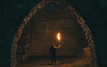 Wallpaper Person Holding Torch in Building Interior
