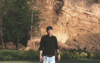 Wallpaper Man Standing on Green Grass Field