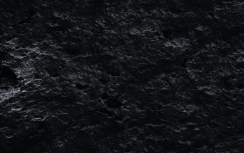 Wallpaper A Black and White Photo of Rocks and Water