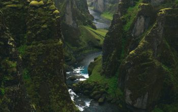 Wallpaper Aerial View Photography of Body of Water Across Green Mountains