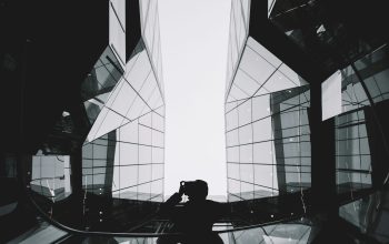 Wallpaper Person in Between Glass Buildings