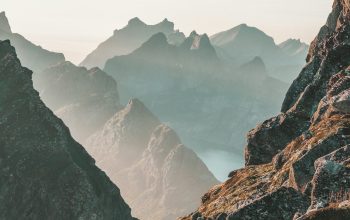 Wallpaper Closeup Photo of Rocky Mountain Under Blue and White Sky