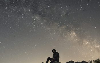 Wallpaper Person Sitting on White Mountain Rock