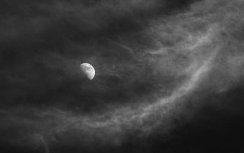 Wallpaper A Black and White Moon in a Cloudy Sky