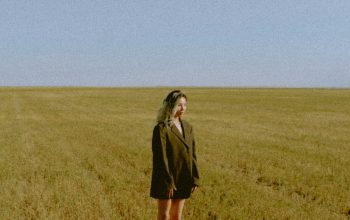 Wallpaper Woman in Black Coat on Green Grass Field