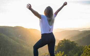 Wallpaper Woman in White Shirt and Black Pants Standing on Rocky Mountain During Daytime