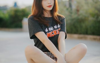 Wallpaper Woman in Gray Sweater and White Pants Sitting on Gray Concrete Floor