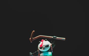 Wallpaper Man in Green Shirt and Black Pants Holding Black and White Stick Figurine