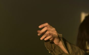Wallpaper Person in Brown Jacket Holding Black Textile