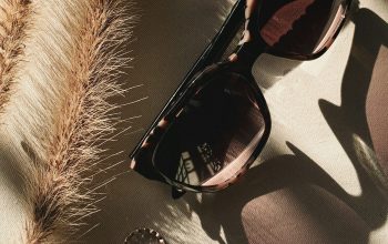 Wallpaper Black Framed Sunglasses on White and Black Textile