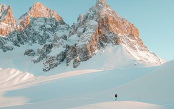 Wallpaper Person Walking on Snow-Covered Mountain