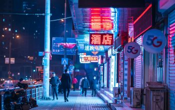 Wallpaper People Walking on Sidewalk at Night