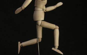 Wallpaper Brown Wooden Human Figure on Black Table