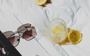 Wallpaper A Book, Sunglasses, and Lemons on a Bed
