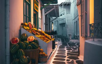 Wallpaper A Cobblestone Street Lined with Fruit and Vegetables