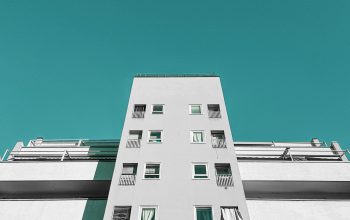 Wallpaper A Tall White Building with Balconies and Windows
