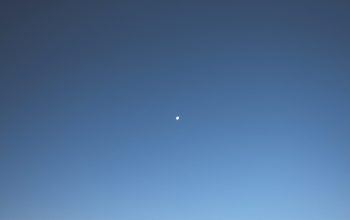 Wallpaper A Mountain View with a Moonlit Sky