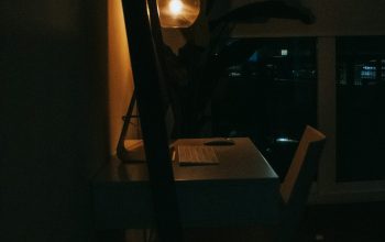 Wallpaper A Dark Room with a Desk and Lamp