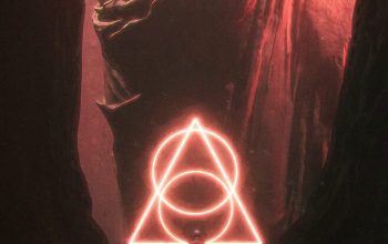 Wallpaper A Person Standing in a Dark Tunnel with a Neon Triangle