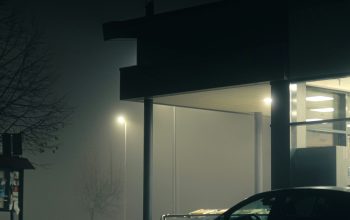 Wallpaper A Car Parked Outside a Building at Night