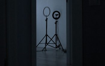 Wallpaper A Dark Room with Two Lights and a Tripod