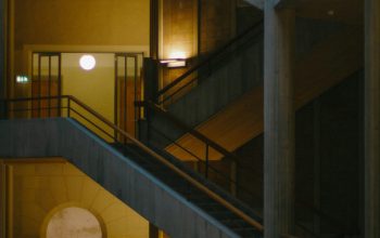Wallpaper A Couple of Stairs in a Building at Night