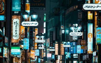 Wallpaper A City Street Filled with Lots of Neon Signs