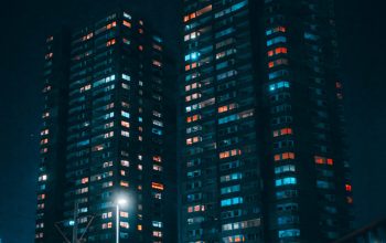Wallpaper A Couple of Tall Buildings Sitting Next to Each Other