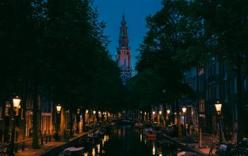 Wallpaper A Canal with Boats and Clock Tower