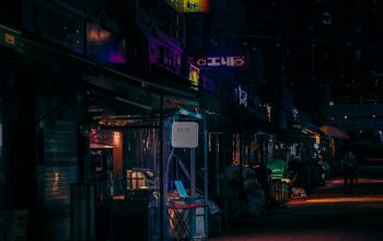 Wallpaper A Dark City Street at Night with Neon Signs