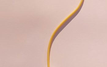 Wallpaper A Yellow Cord Connected to a White Object