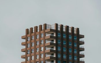 Wallpaper A Tall Brown Building with Lots of Windows
