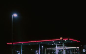 Wallpaper A Gas Station Lit Up at Night