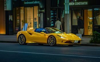 Wallpaper A Yellow Sports Car Parked on the Roadside