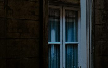 Wallpaper A Window with a House Reflection
