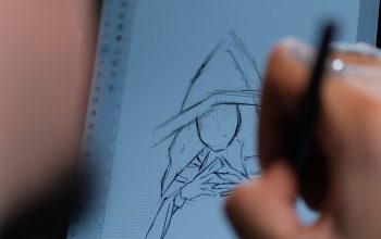Wallpaper A Person Drawing on a Tablet with a Pen