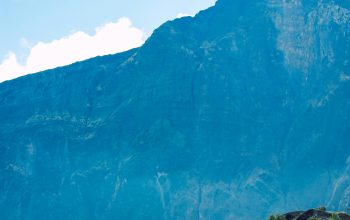 Wallpaper People Stand on a Cliff, Overlooking a Mountain