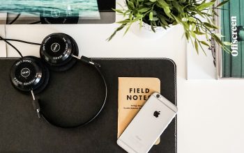 Wallpaper Black Headphones Beside Space Gray iPhone on Brown Table