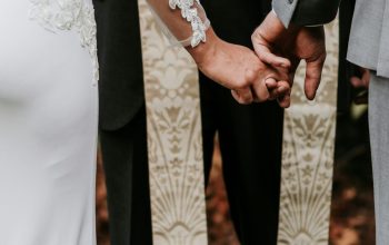 Wallpaper Man and Woman Holding Hands in Front of Priest