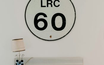 Wallpaper White and Green Wooden Desk with Brown Lampshade near LRC 60 Wall Signage