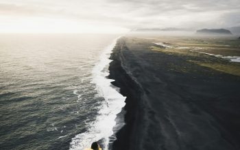 Wallpaper Man on Top of Hill Near Body of Water